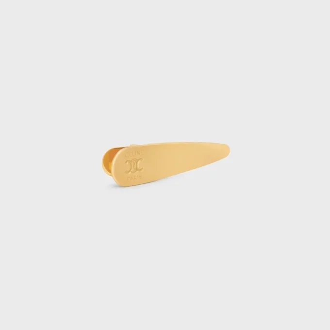 Barrette CELINE en laiton avec finition dorée, acier et zamak