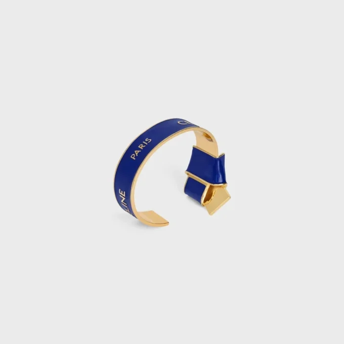Bracelet CELINE à nœud en émail et laiton avec finition dorée Bracelet CELINE à nœud en émail et laiton avec finition dorée