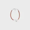 Bracelet à nœud en cuir de veau et laiton avec finition rhodiée Bracelet à nœud en cuir de veau et laiton avec finition rhodiée