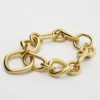 Charms Gourmette fine moderne en laiton avec finition dorée Charms Gourmette fine moderne en laiton avec finition dorée