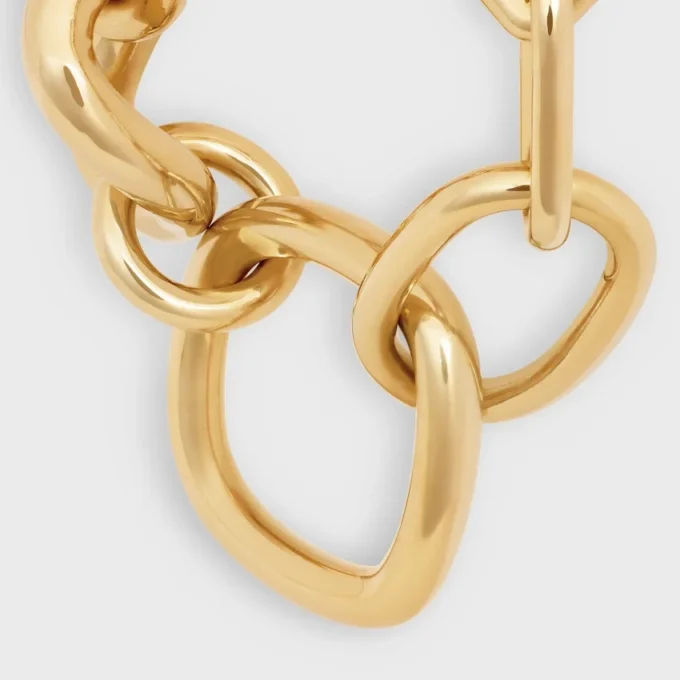 Charms Gourmette moderne et imposante en laiton avec finition dorée Charms Gourmette moderne et imposante en laiton avec finition dorée