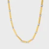 Collier long à breloques en laiton avec finition or et rhodium Collier long à breloques en laiton avec finition or et rhodium