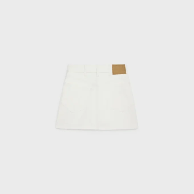 Mini-jupe brodée en denim blanc délavé brut Mini-jupe brodée en denim blanc délavé brut