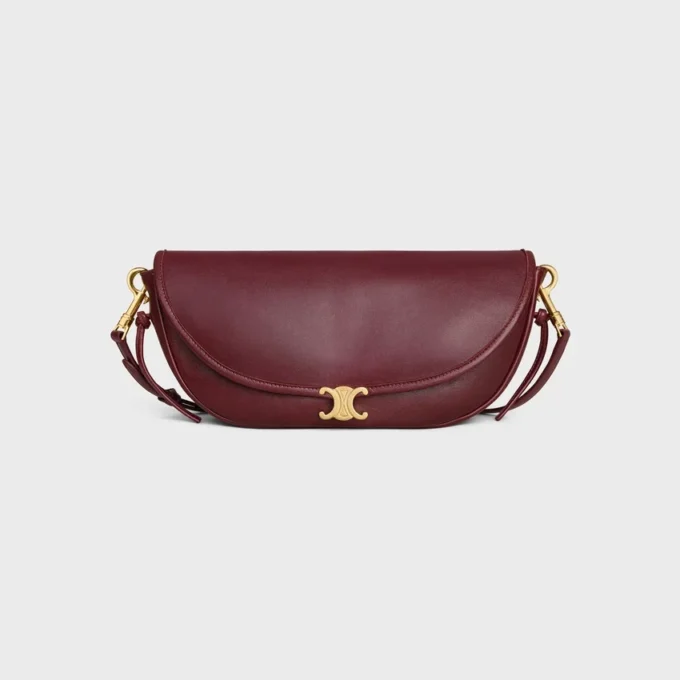 Petit sac Halfmoon Soft Triomphe en cuir d’agneau souple et brillant Petit sac Halfmoon Soft Triomphe en cuir d’agneau souple et brillant