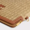 Petite pochette avec bandoulière en textile effet raphia et cuir de veau