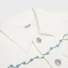 Veste de camionneur brodée en denim blanc délavé brut